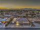 An aerial view of a neighborhood with a mountain range visible in the distance at dusk at 1202 S Rancho Dr, Las Vegas, NV 89102