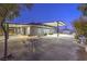 Wide angle view of the backyard with covered patio, desert landscaping, and furniture at 1202 S Rancho Dr, Las Vegas, NV 89102