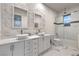 Bright bathroom features a double vanity with marble countertop and a glass-enclosed shower/tub at 1202 S Rancho Dr, Las Vegas, NV 89102