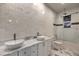 Modern bathroom with double sinks, bathtub, and walk-in shower at 1202 S Rancho Dr, Las Vegas, NV 89102