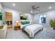 Inviting bedroom featuring an accent painting over the bed, light walls and flooring, and natural light at 1202 S Rancho Dr, Las Vegas, NV 89102