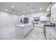 Open kitchen featuring an island with marble countertops and a dining area, perfect for entertaining at 1202 S Rancho Dr, Las Vegas, NV 89102