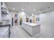 Modern kitchen with white cabinetry, marble countertops, stainless steel appliances, and a kitchen island at 1202 S Rancho Dr, Las Vegas, NV 89102