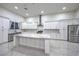 Beautiful bright kitchen featuring white cabinetry, marble countertops, stainless steel appliances, and kitchen island at 1202 S Rancho Dr, Las Vegas, NV 89102