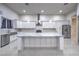 Bright kitchen with white cabinetry, marble countertops, stainless steel appliances, and a central island at 1202 S Rancho Dr, Las Vegas, NV 89102