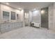 Main bathroom featuring dual sinks, a marble standalone tub, and a separate glass shower at 1202 S Rancho Dr, Las Vegas, NV 89102