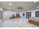 Spacious main bedroom with a ceiling fan, media center, double doors, and shiny tile flooring at 1202 S Rancho Dr, Las Vegas, NV 89102