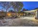 Wide angle view of a large patio with an overhead covering, plants, and seating at 1202 S Rancho Dr, Las Vegas, NV 89102