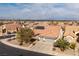 Aerial view of single-story house with solar panels, two-car garage, and desert landscaping at 1592 Bamboo Bay Dr, Henderson, NV 89012