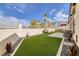 Artificial turf backyard with patio and seating area at 1592 Bamboo Bay Dr, Henderson, NV 89012