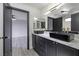 Modern bathroom with double vanity and black vessel sinks at 1592 Bamboo Bay Dr, Henderson, NV 89012