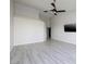 Spacious bedroom with wood-look floors and ceiling fan at 1592 Bamboo Bay Dr, Henderson, NV 89012