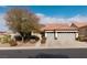 House exterior with gray double garage doors and desert landscaping at 1592 Bamboo Bay Dr, Henderson, NV 89012