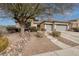 Single-story home with gray double garage doors and drought-tolerant landscaping at 1592 Bamboo Bay Dr, Henderson, NV 89012