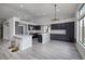 Modern kitchen with dark cabinetry, quartz countertops, and herringbone backsplash at 1592 Bamboo Bay Dr, Henderson, NV 89012