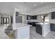 Updated kitchen, featuring dark cabinetry and quartz countertops at 1592 Bamboo Bay Dr, Henderson, NV 89012