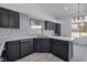 Modern kitchen with dark cabinets and quartz countertops at 1592 Bamboo Bay Dr, Henderson, NV 89012