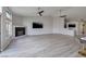 Spacious living room featuring hardwood floors and a corner fireplace at 1592 Bamboo Bay Dr, Henderson, NV 89012