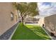 Landscaped side yard with artificial turf and gravel at 1592 Bamboo Bay Dr, Henderson, NV 89012