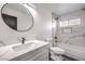 Modern bathroom with marble tile, white vanity, and a bathtub at 1700 Breezewood Dr, Las Vegas, NV 89108