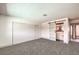 Spacious bedroom with gray carpet and barn door to ensuite bathroom at 1700 Breezewood Dr, Las Vegas, NV 89108