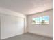 Bright bedroom with grey carpet, large closet, and window with backyard view at 1700 Breezewood Dr, Las Vegas, NV 89108