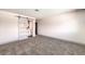 Modern bedroom with gray carpet and barn door to ensuite bathroom at 1700 Breezewood Dr, Las Vegas, NV 89108