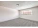 Bright bedroom featuring gray carpet and a window at 1700 Breezewood Dr, Las Vegas, NV 89108