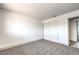 Light bedroom with grey carpet and double door closet at 1700 Breezewood Dr, Las Vegas, NV 89108