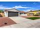 Updated single story home with a dark gray garage door at 1700 Breezewood Dr, Las Vegas, NV 89108