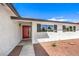 Modern red front door and updated gray shutters at 1700 Breezewood Dr, Las Vegas, NV 89108