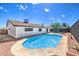 Inviting kidney-shaped pool with a large concrete patio at 1700 Breezewood Dr, Las Vegas, NV 89108