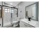 Modern bathroom featuring a glass shower with black trim, white marble, and a contemporary vanity with a black faucet at 1906 Palora Ave, Las Vegas, NV 89169