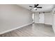 Bedroom with ceiling fan, barn door, and grey walls with wood-look flooring at 1906 Palora Ave, Las Vegas, NV 89169