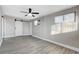 Spacious bedroom featuring grey walls, a barn door, and laminate wood flooring at 1906 Palora Ave, Las Vegas, NV 89169