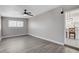 Bedroom with a view into the kitchen, ceiling fan, and grey walls at 1906 Palora Ave, Las Vegas, NV 89169