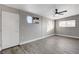 Bright bedroom with ceiling fan, large window, and grey laminate flooring at 1906 Palora Ave, Las Vegas, NV 89169