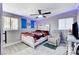 Spacious bedroom with gray walls, ceiling fan, and a comfortable seating area at 1906 Palora Ave, Las Vegas, NV 89169