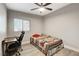 Cozy bedroom with neutral walls, light gray flooring, and a window bringing in natural light for a calm feel at 1906 Palora Ave, Las Vegas, NV 89169