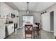 Modern kitchen with white cabinets, island, and sliding barn door at 1906 Palora Ave, Las Vegas, NV 89169