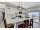 Modern kitchen with stainless steel appliances, white cabinets, a sleek island, and contemporary lighting fixtures at 1906 Palora Ave, Las Vegas, NV 89169