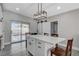 Modern kitchen with white cabinets, quartz countertops, and a kitchen island at 1906 Palora Ave, Las Vegas, NV 89169