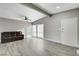 Living room with hardwood floors, ceiling fan, and large windows at 1906 Palora Ave, Las Vegas, NV 89169