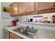 Modern kitchen featuring a double sink, light wood cabinets, and a view into the living area at 2044 Mesquite Ln # 302, Laughlin, NV 89029