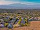 Aerial view of houses and community, mountain backdrop at 2064 Poetry Ave, Henderson, NV 89052