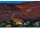 Aerial view of house nestled on a hillside with desert landscape at 2064 Poetry Ave, Henderson, NV 89052