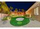 Backyard putting green with a sand trap and desert landscaping, perfect for outdoor entertaining at 2064 Poetry Ave, Henderson, NV 89052