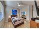 Bedroom featuring a bed, closet, wood floors, modern art and ceiling fan with light fixture at 2064 Poetry Ave, Henderson, NV 89052