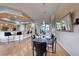 Open dining room with hardwood floors and view into kitchen at 2064 Poetry Ave, Henderson, NV 89052