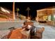 Fire pit and seating area on a patio at night at 2064 Poetry Ave, Henderson, NV 89052